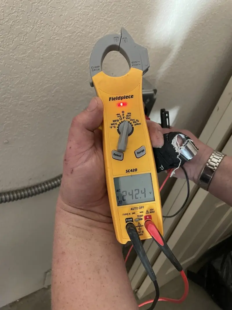 Voltage testing with clamp meter during Ceiling Fan Installation in Piggott